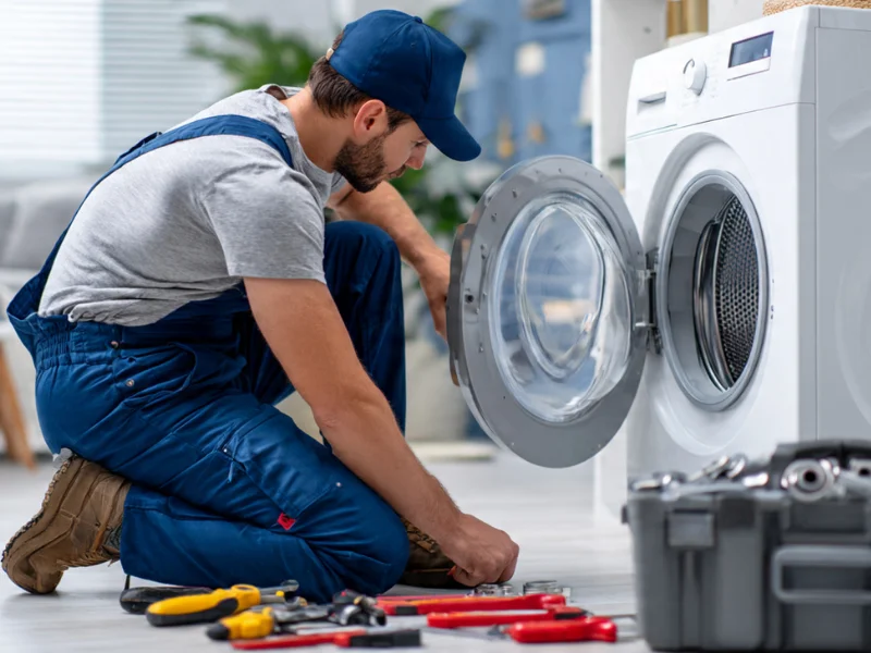 Licensed technician repairing washing machine in Dubai